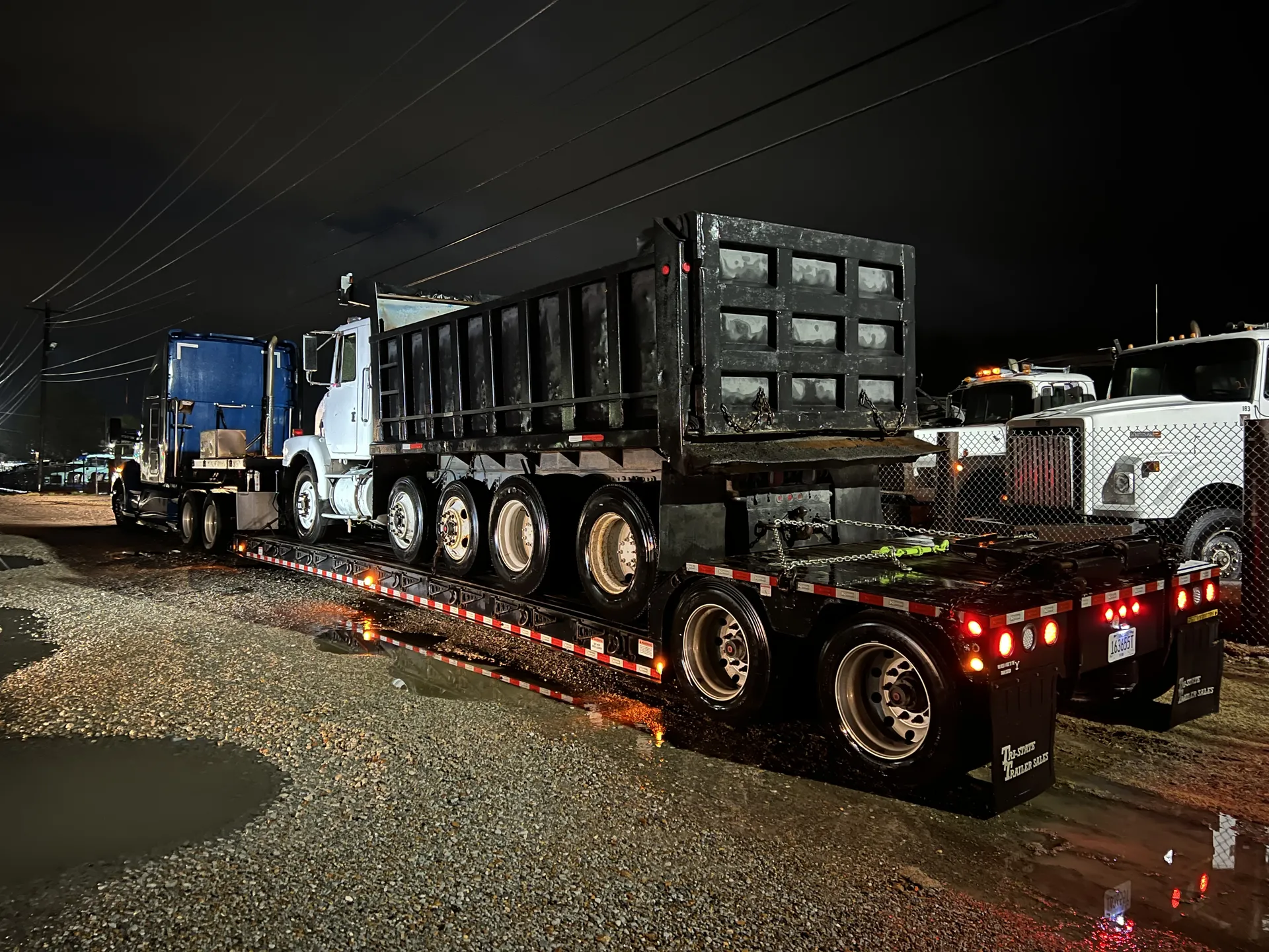 Patriot Services night haul with dump truck on lowboy